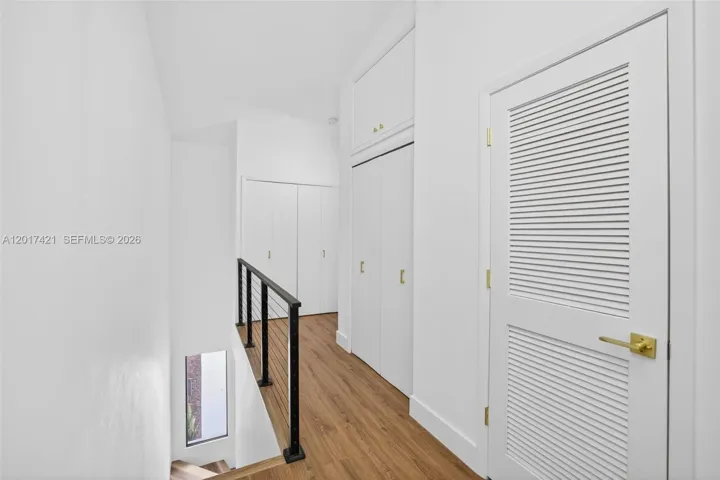 New railing / balister system w/ cables & aluminum. New doors & hardware & freshly pained. AC closet to right, storage closet and Laundry Area straight ahead