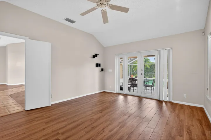 The primary bedroom has new impacted sliders that give you immediate access to the screened in patio with a pool.