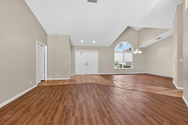 Step inside this $2,411SF home, with high vaulted ceilings and new porcelain tile floors throughout.