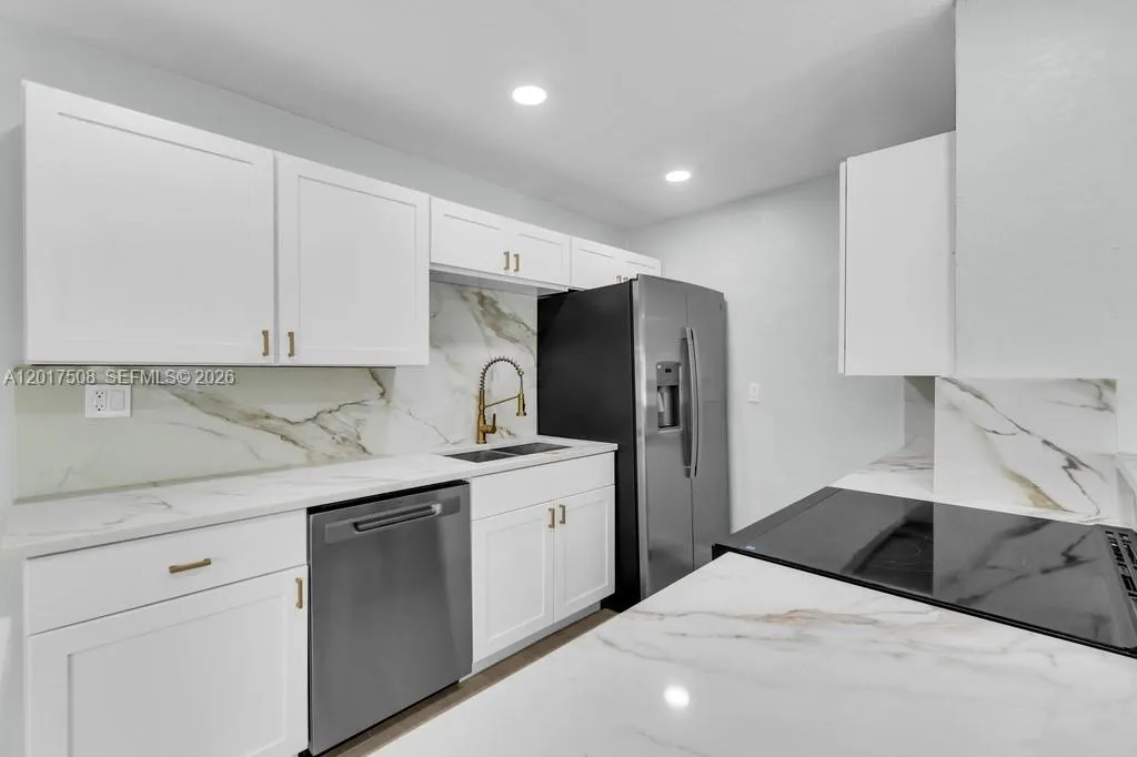 New Fantasy Quartz Countertops & Backsplsh w/ Gold Accents