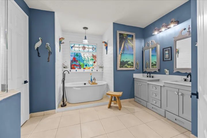 Customized primary bath with soaking tub, updated custom vanities and updated shower with frameless shower enclosure...