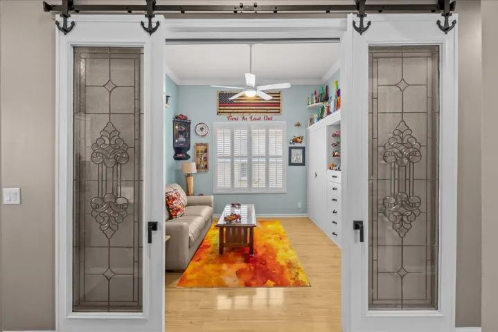 Guest bedroom with statement glass decorative barn doors