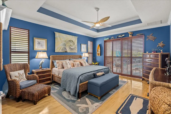 Accented tray ceilings and beautiful custom plantation shutters overlooking the pool area and lake....