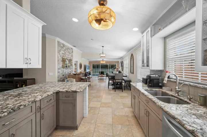 Open, breezy flow from the kitchen through the sliders to the pool area.