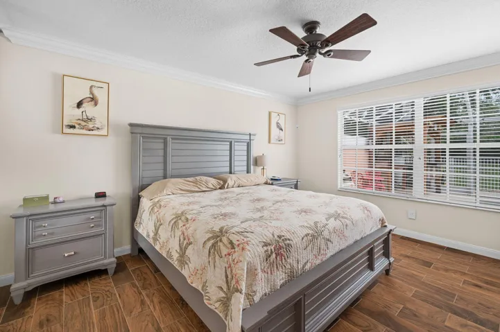 Primary bedroom w/views of the pool/garden area