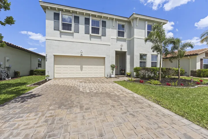 Attractive architecture, mature landscaping, and an inviting front entrance create exceptional curb appeal.