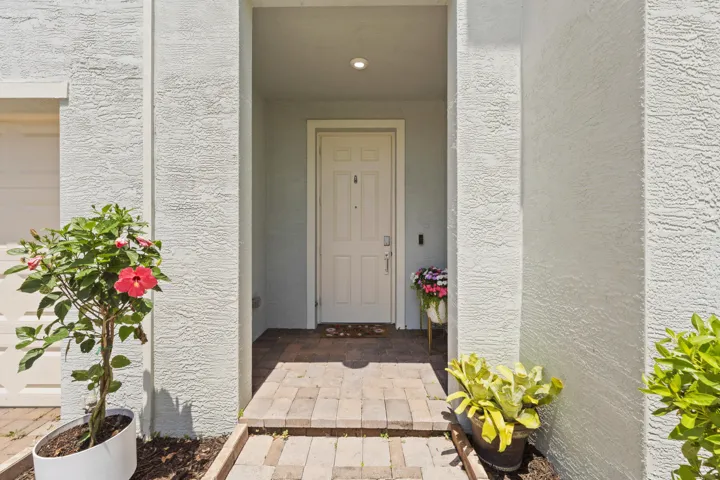 Enjoy a welcoming covered front porch with elegant architectural details and keyless entry.