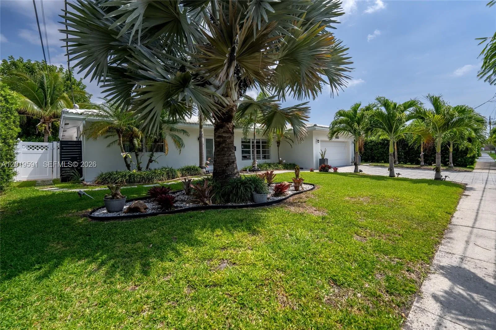 Spacious tropical yard area with lush landscaping and relaxing outdoor waterfront atmosphere.