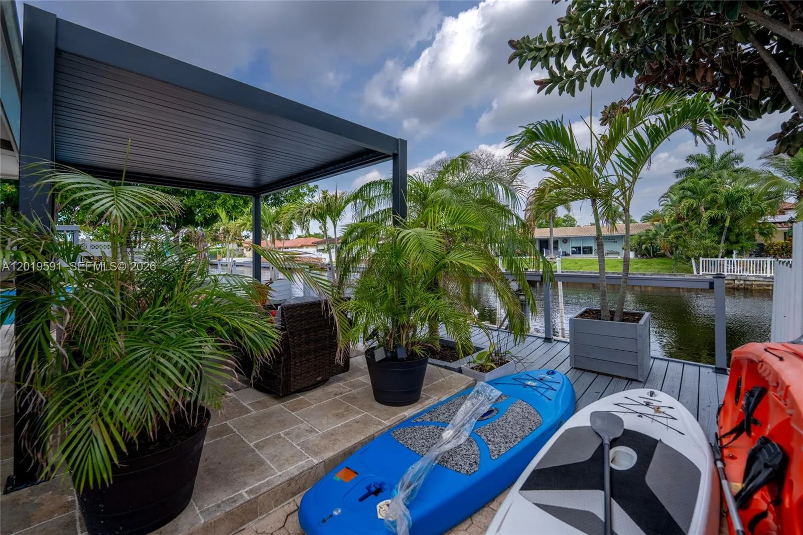 Tropical outdoor lounge and waterfront patio area perfect for relaxing, entertaining, and enjoying Florida living.