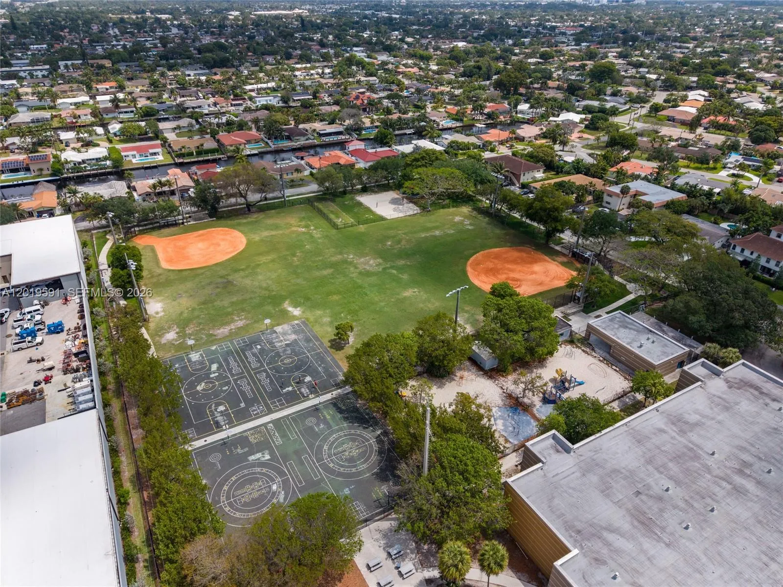 Aerial neighborhood view showcasing prime waterfront location near parks, recreation, and Fort Lauderdale attractions.