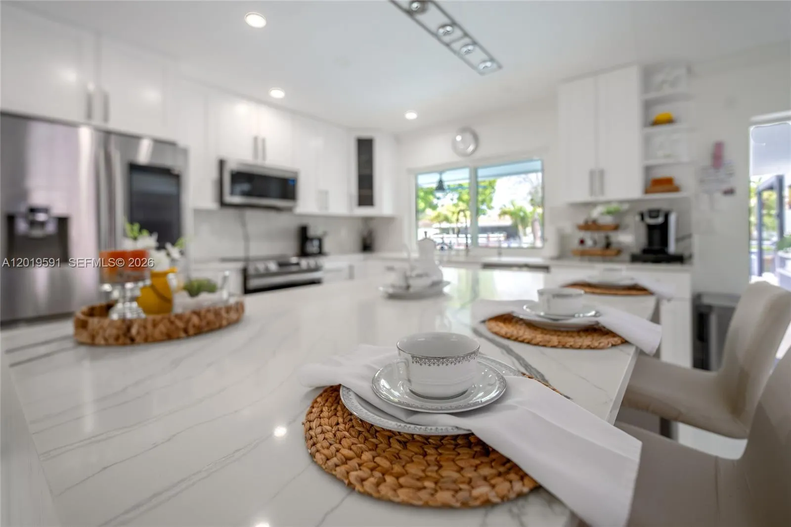 Bright chef-style kitchen with modern finishes, natural light, and open-concept luxury design.