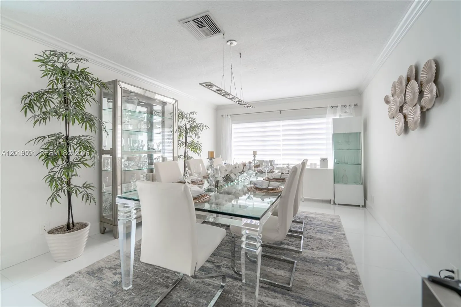 Sophisticated dining area with modern décor, natural lighting, and perfect space for gathering and entertaining.