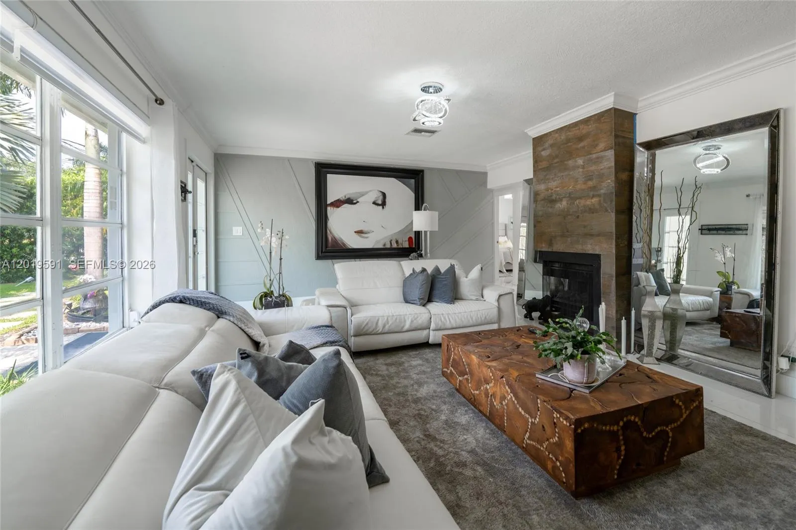 Bright modern living room with open-concept design, elegant finishes, and poolside natural light.