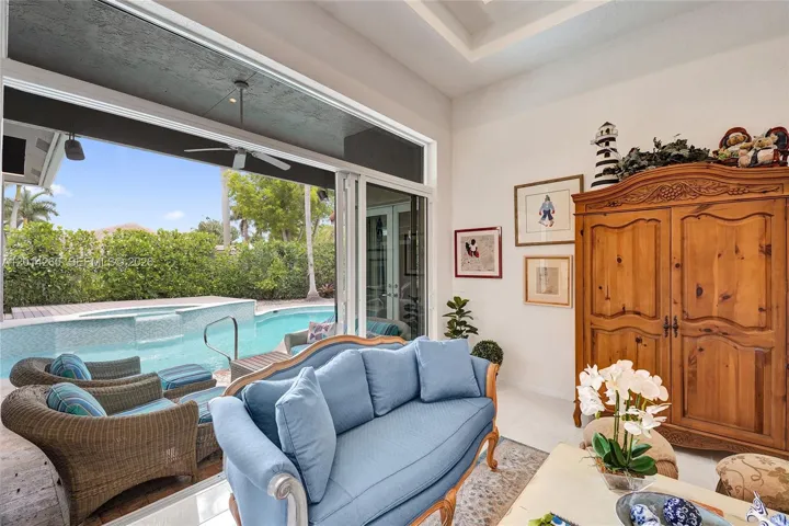 Living room opens up to backyard & pool area. Impact doors slide into each other.