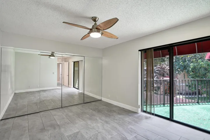 Mirrored sliding doors to wall to wall closet and sliders to balcony