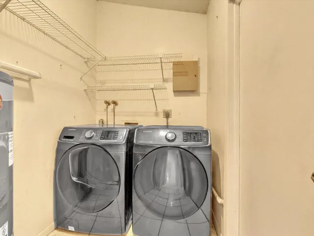 Laundry room with washer, dryer, shelving, utility storage, and a practical setup for everyday household needs.