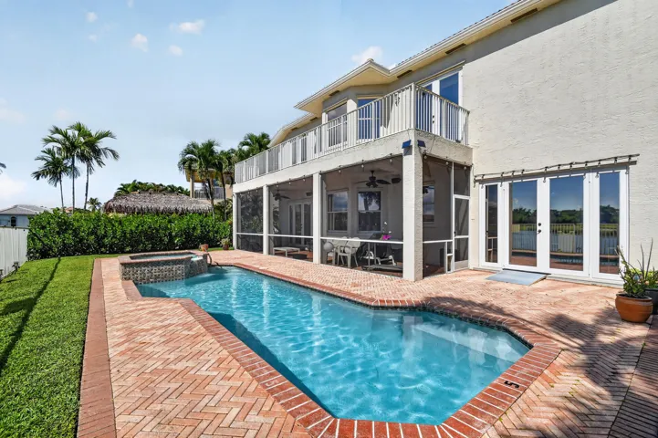 Rear of home showing Screened Patio & balcony