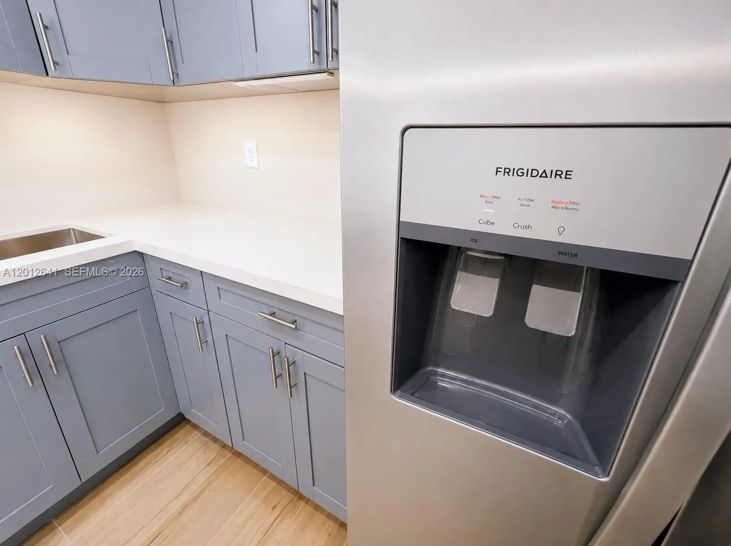 SPACIOUS CUSTOM DESIGNED QUARTZ COUNTER AND CUSTOM FINISHED CABINET SYSTEMS