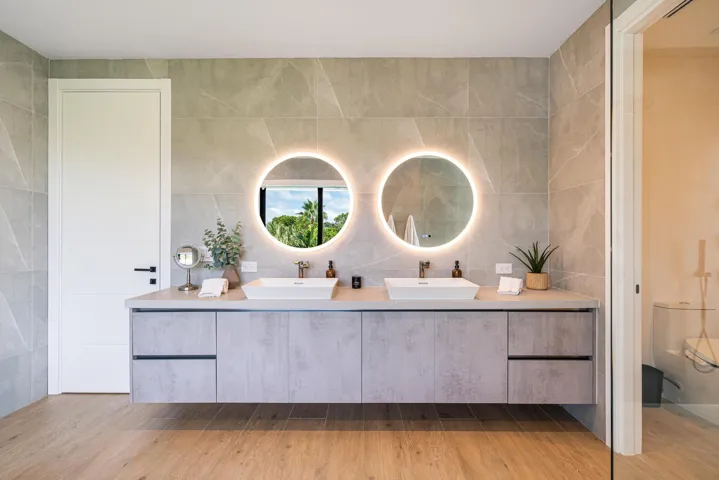 Dual vanities featuring touch-activated mirrors and refined, modern sophistication.