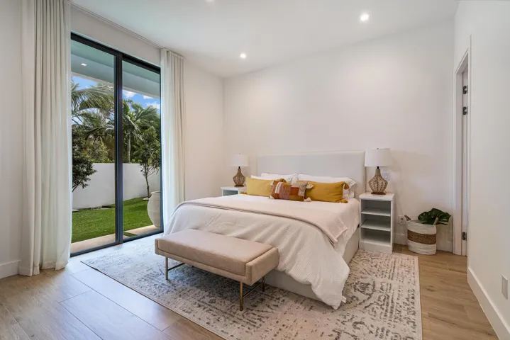 Front downstairs bedroom with sliding glass doors opening to a private courtyard.