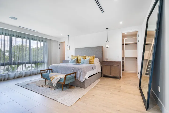 Lavish primary suite featuring motorized shades and designer blinds.