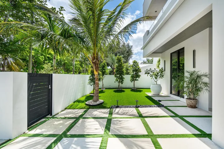 Meticulously manicured landscaping enhances the property’s refined exterior throughout.