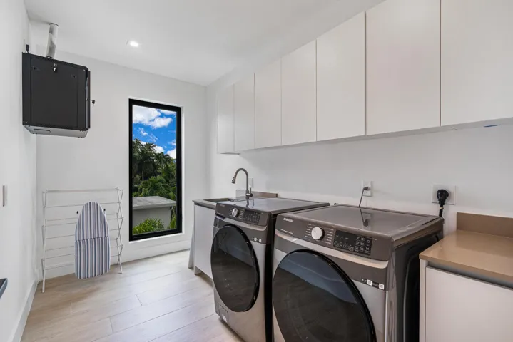 Spacious upstairs laundry room with convenient, well-designed layout.