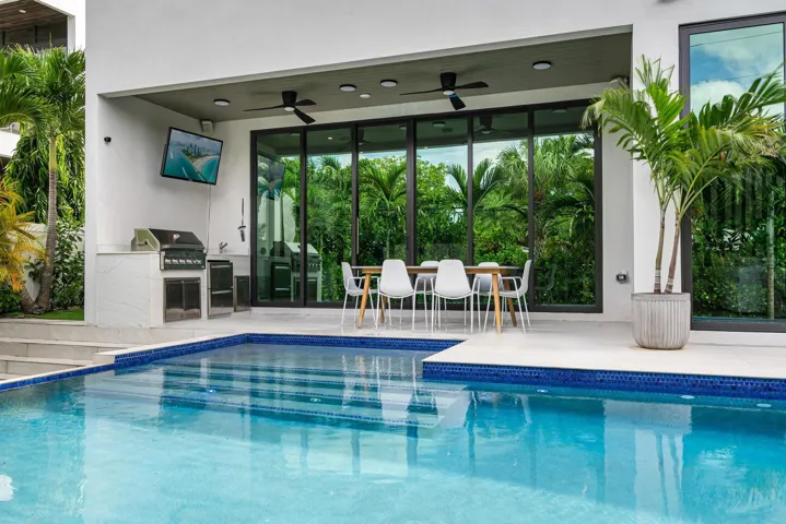 Resort-style backyard with infinity pool, spa and summer kitchen.