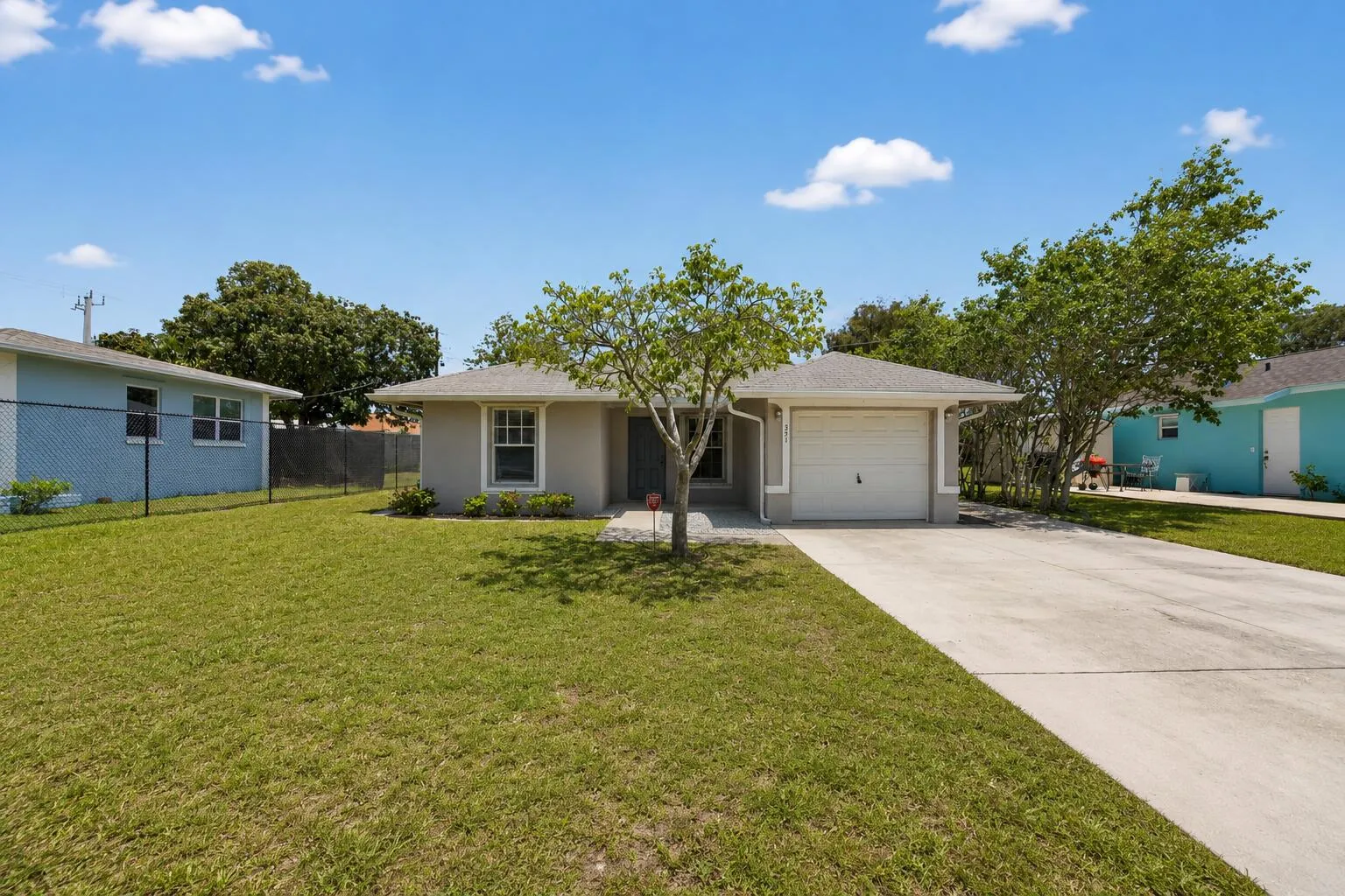 Front exterior with an oversized driveway and inviting curb appeal