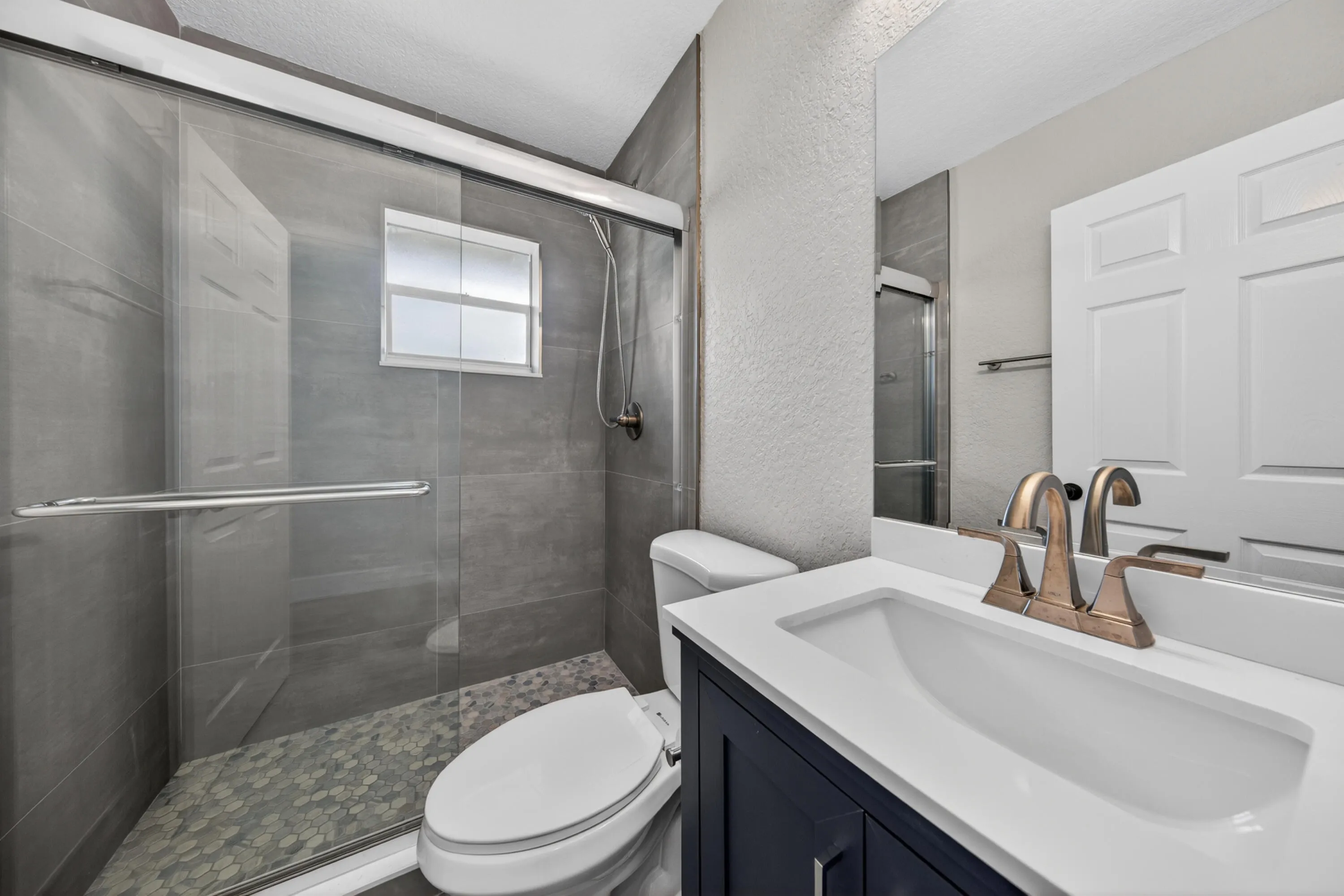Second bathroom with updated finishes and a glass shower