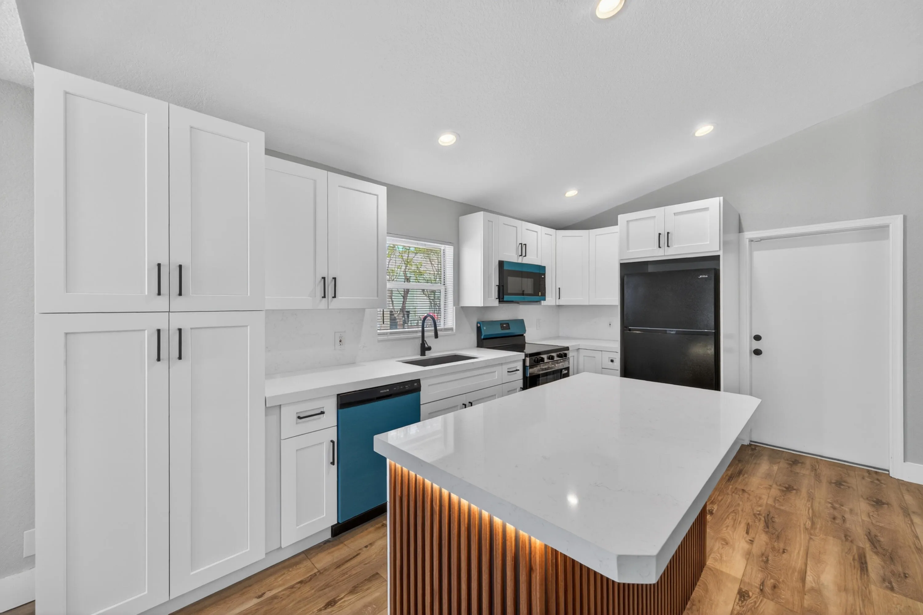 Modern kitchen with updated cabinetry, quartz countertops, and contemporary finishes