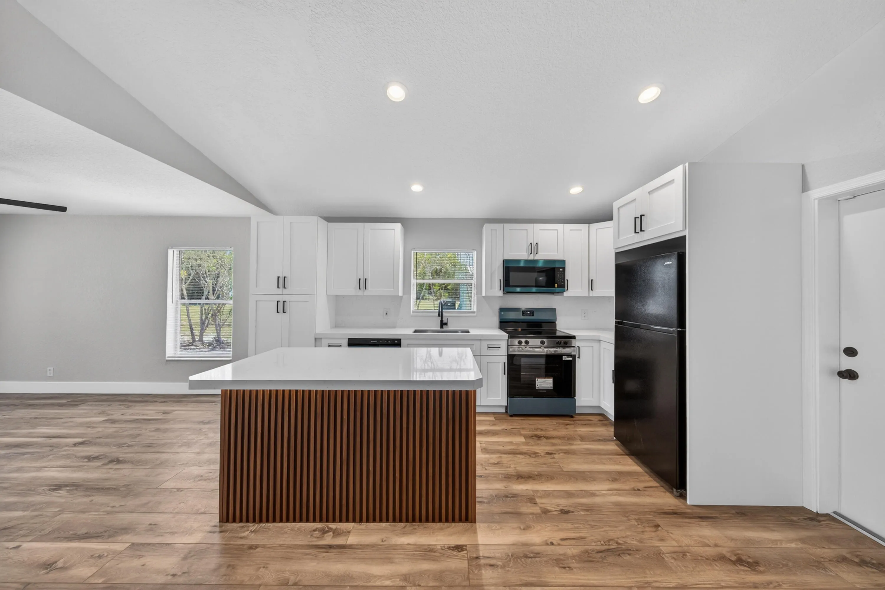 Bright open kitchen featuring a large center island and seamless flow into the main living area