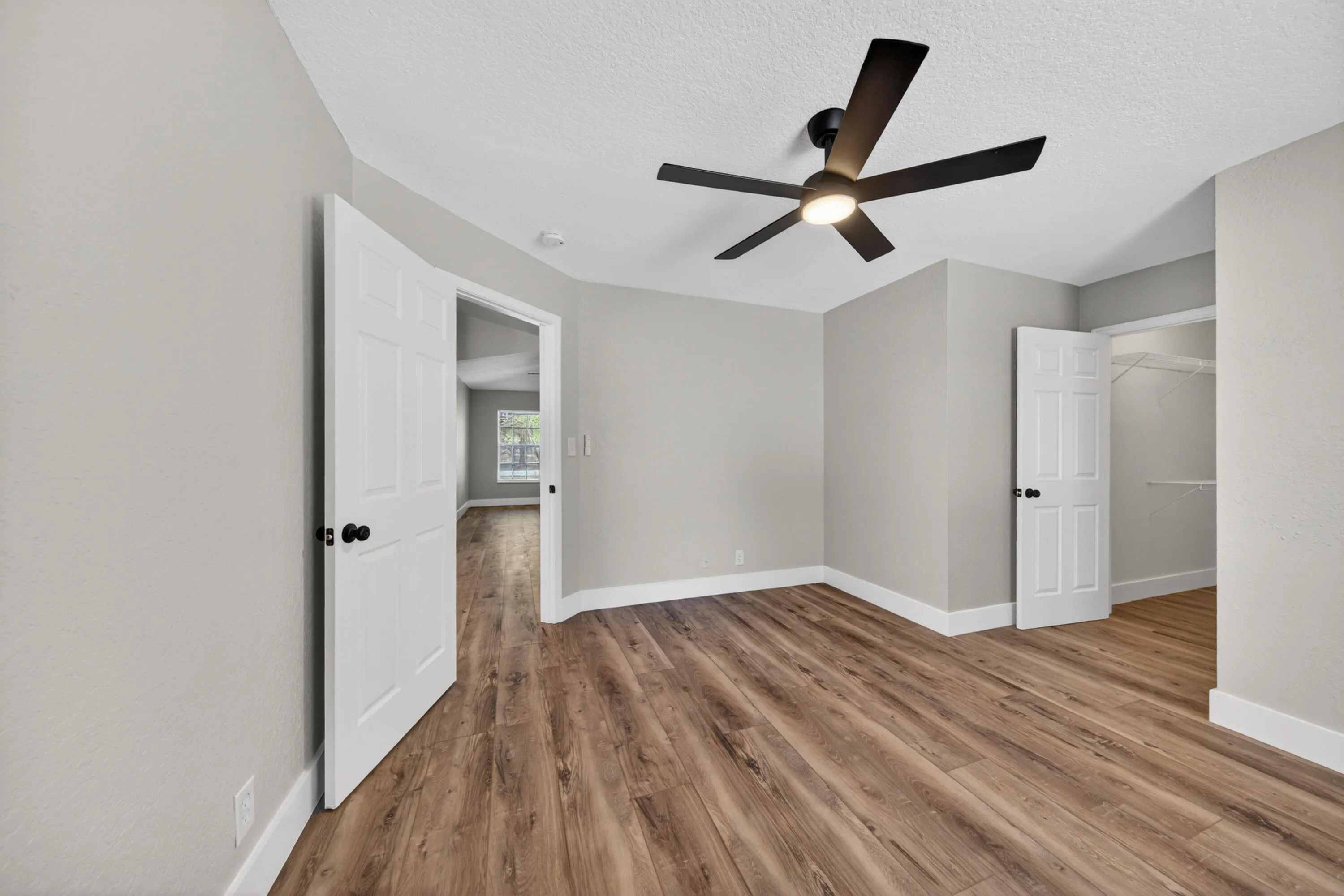 Primary bedroom featuring updated flooring and closet access