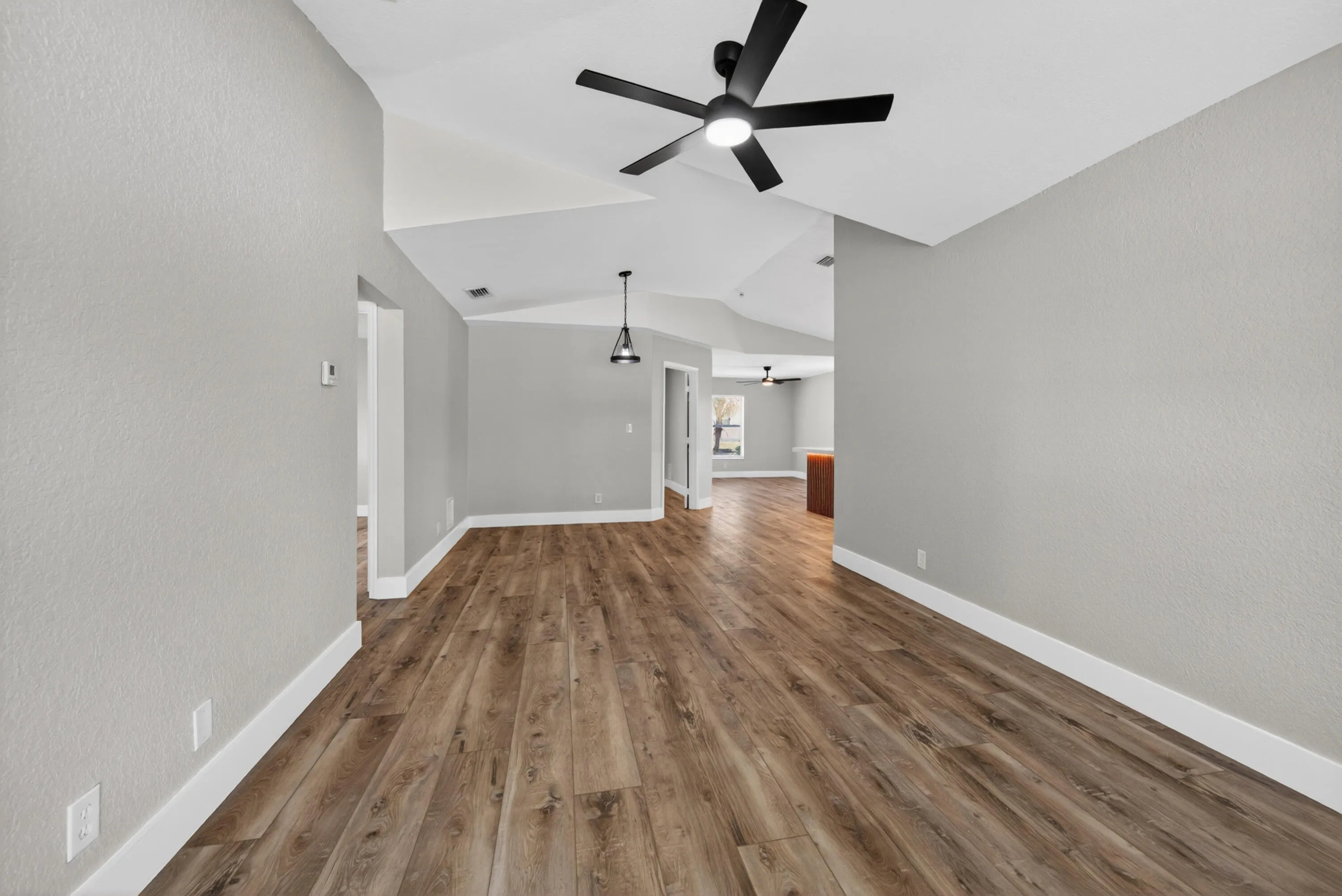 Living and dining area connecting to the kitchen with an open layout