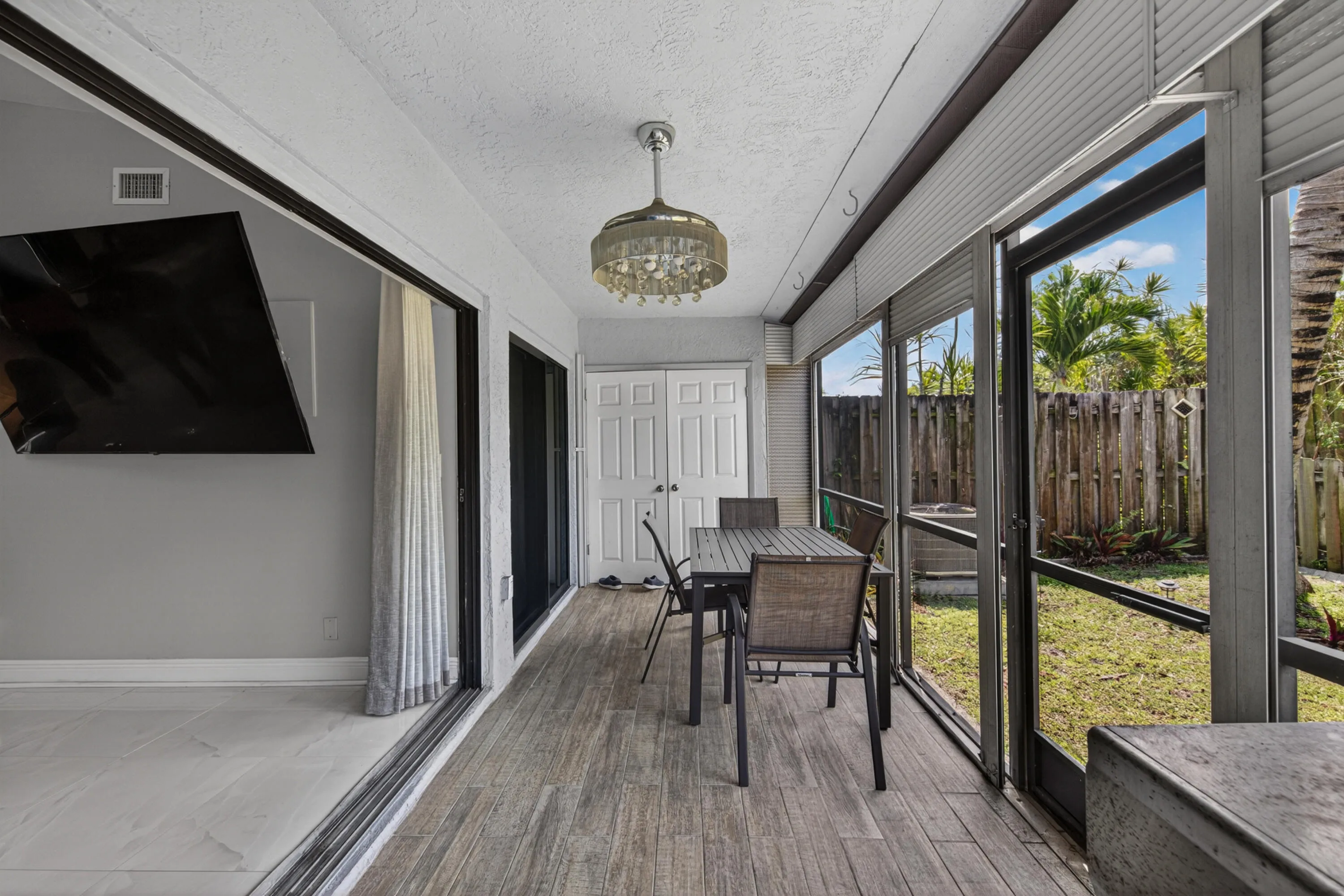 Screened patio with tile floors and accordion sliding doors