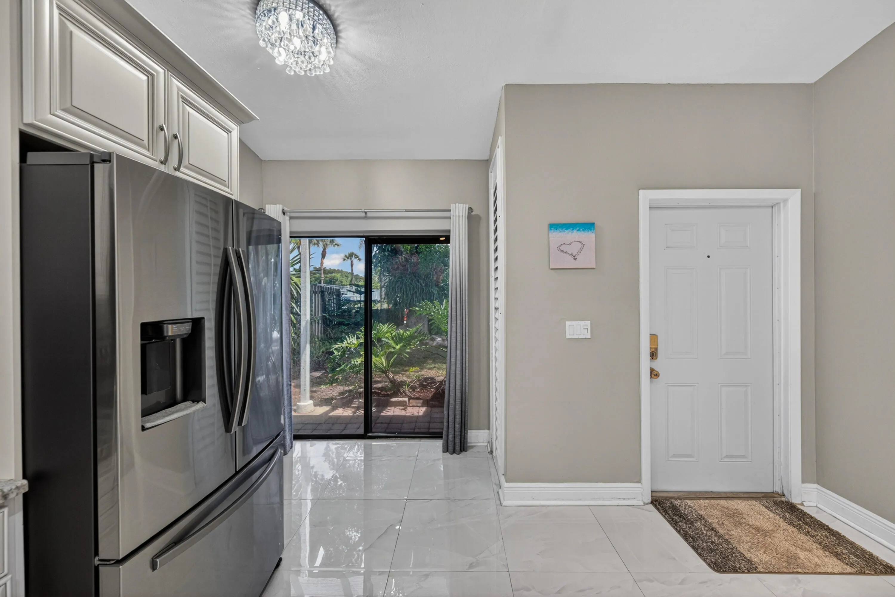 Kitchen with pantry and sliding door access to outside
