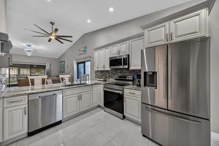 Fully updated kitchen with stone countertops and stainless steel appliances