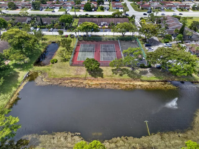 Tennis court overlooking community lake