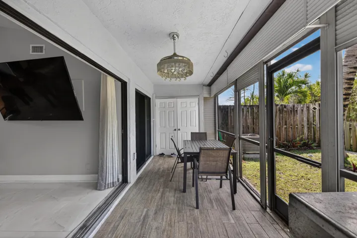 Screened patio with tile floors and accordion sliding doors