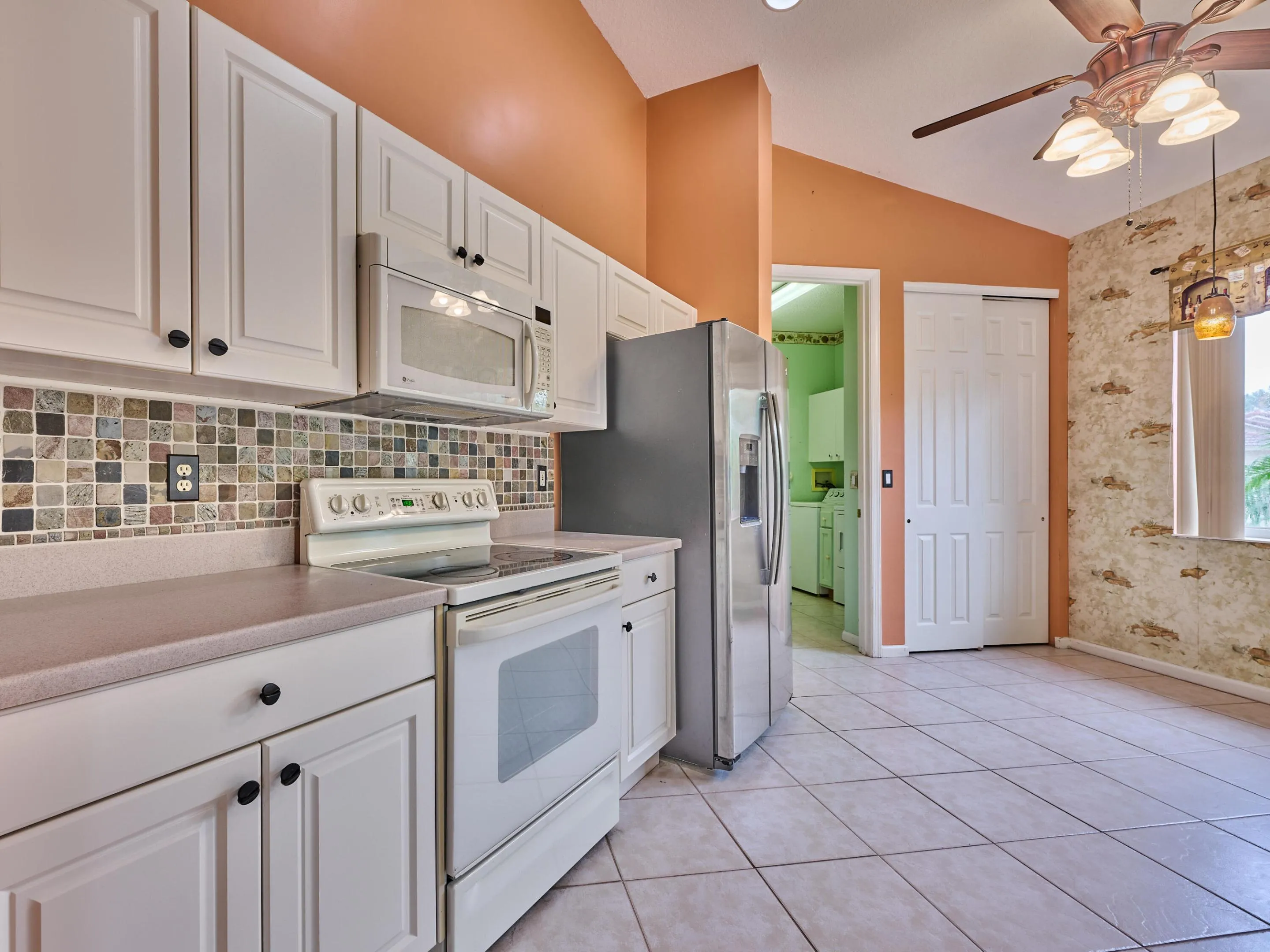 Corion counters, tiled backsplash, white cabinets