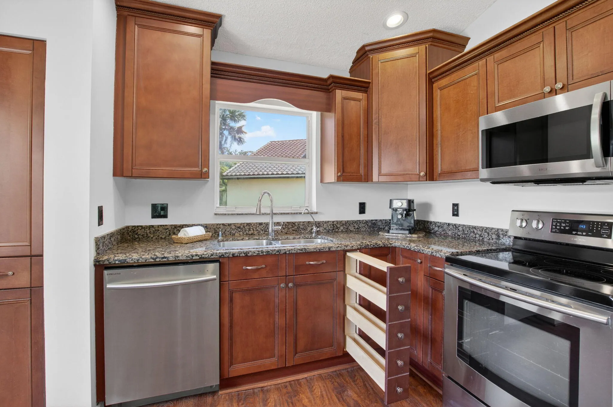 Kitchen showing base cabinet spice rack detail