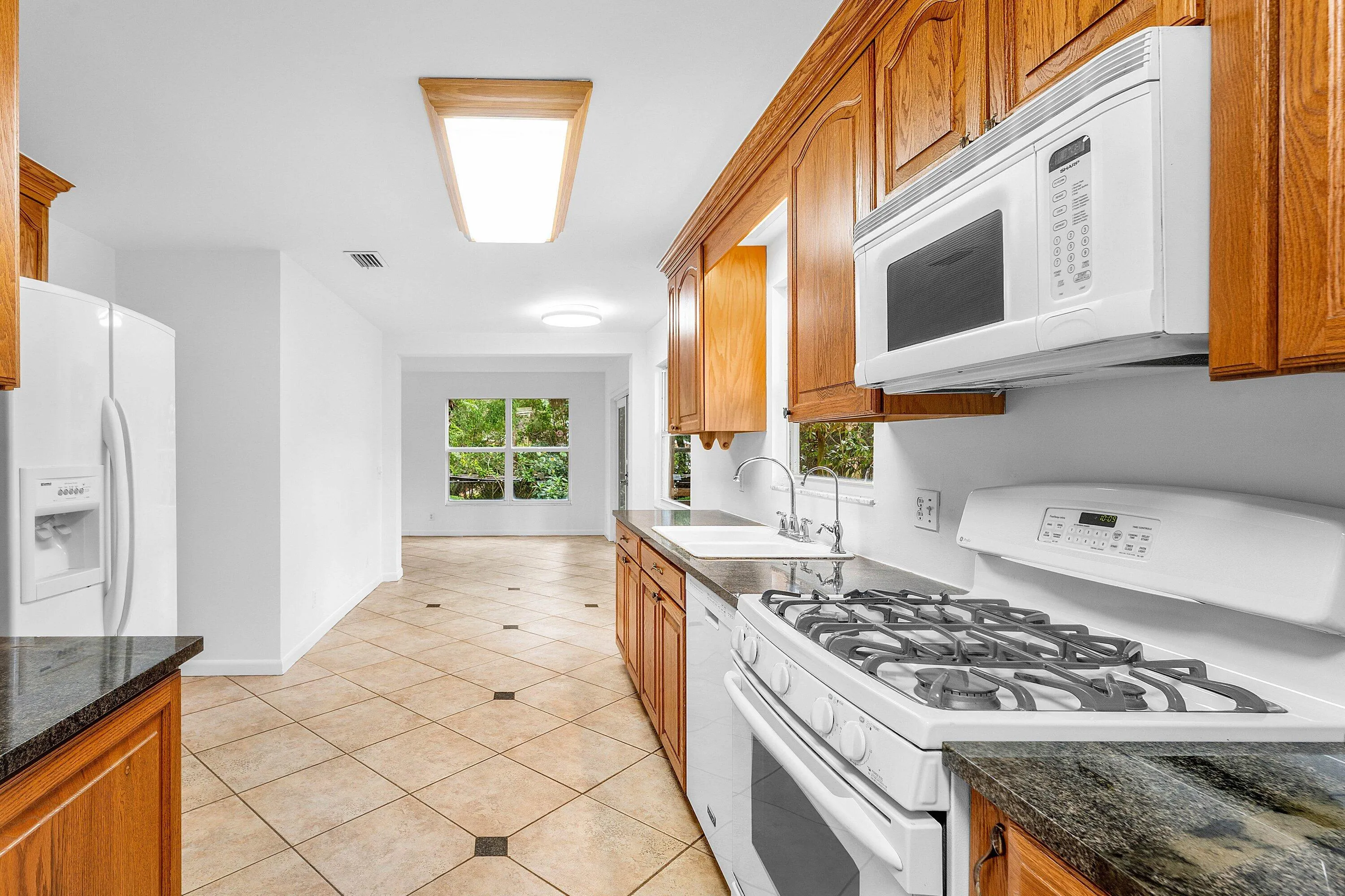 Granite counter tops. Wood cabinets. Gas range