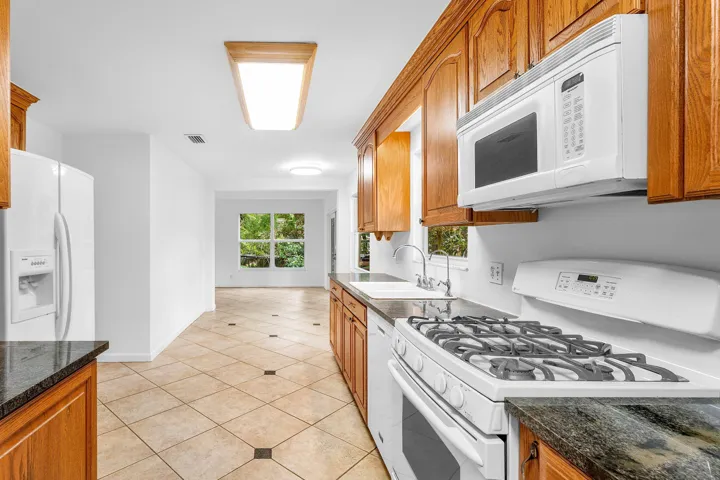 Granite counter tops. Wood cabinets. Gas range