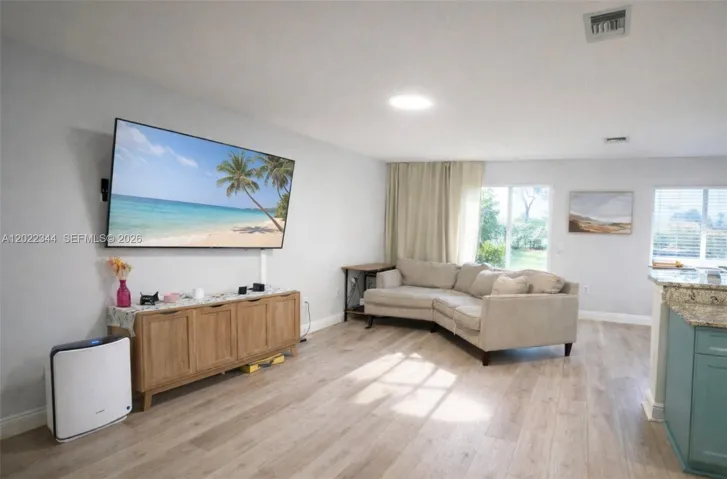 Bright updated Boynton Beach townhome with open living spaces, modern finishes, spacious bedrooms & peaceful backyard views in a resort-style community near shopping, dining & major routes.
