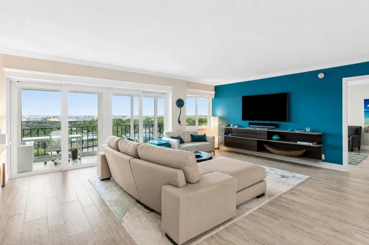 Living room has sliders to a glass enclosed balcony with expansive direct Intracoastal waterway and city views.