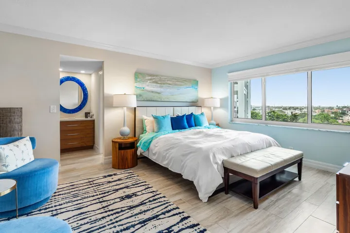 Spacious primary bedroom Suite with a sitting area, built out walk in closet, dresssing area and a tub/shower in bathroom.