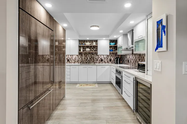 Designer kitchen with custom cabinetry, Monogram appliances & quartz countertops.