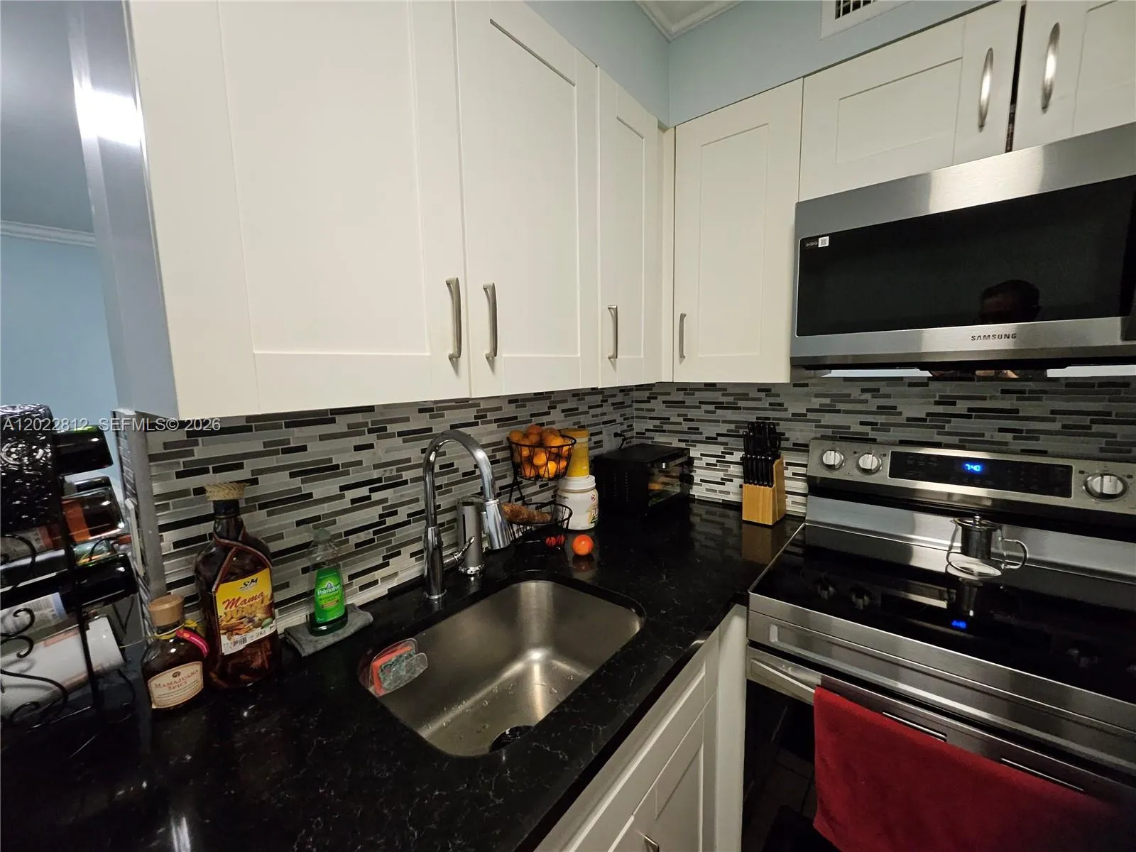 Pull out spray hose....Upgraded cabinets, Granite countertops, Custom back splash and all stainless-steel appliances.
