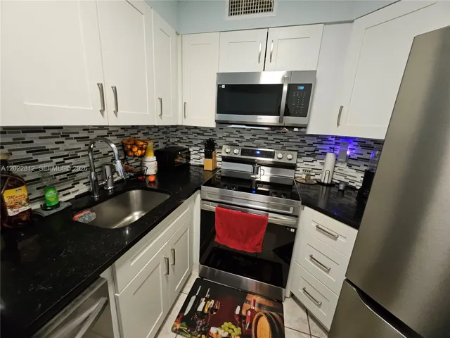 Upgraded cabinets, Granite countertops, Custom back splash and all stainless-steel appliances.
