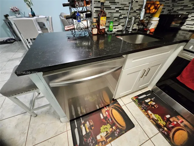 Upgraded cabinets, Granite countertops, Custom back splash and all stainless-steel appliances.